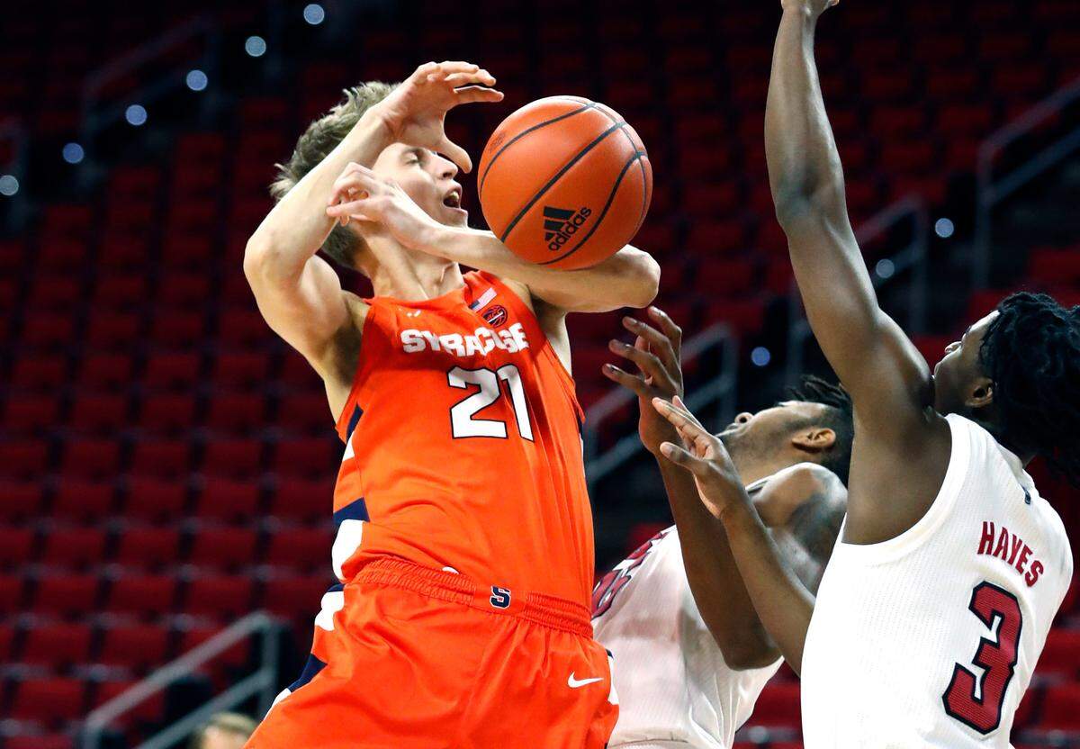 Syracuse’s Marek Dolezaj (21) is fouled by N.C. State’s Manny Bates (15) during the first half of N.C. State’s game against Syracuse at PNC Arena in Raleigh, N.C., Tuesday, February 9, 2021.