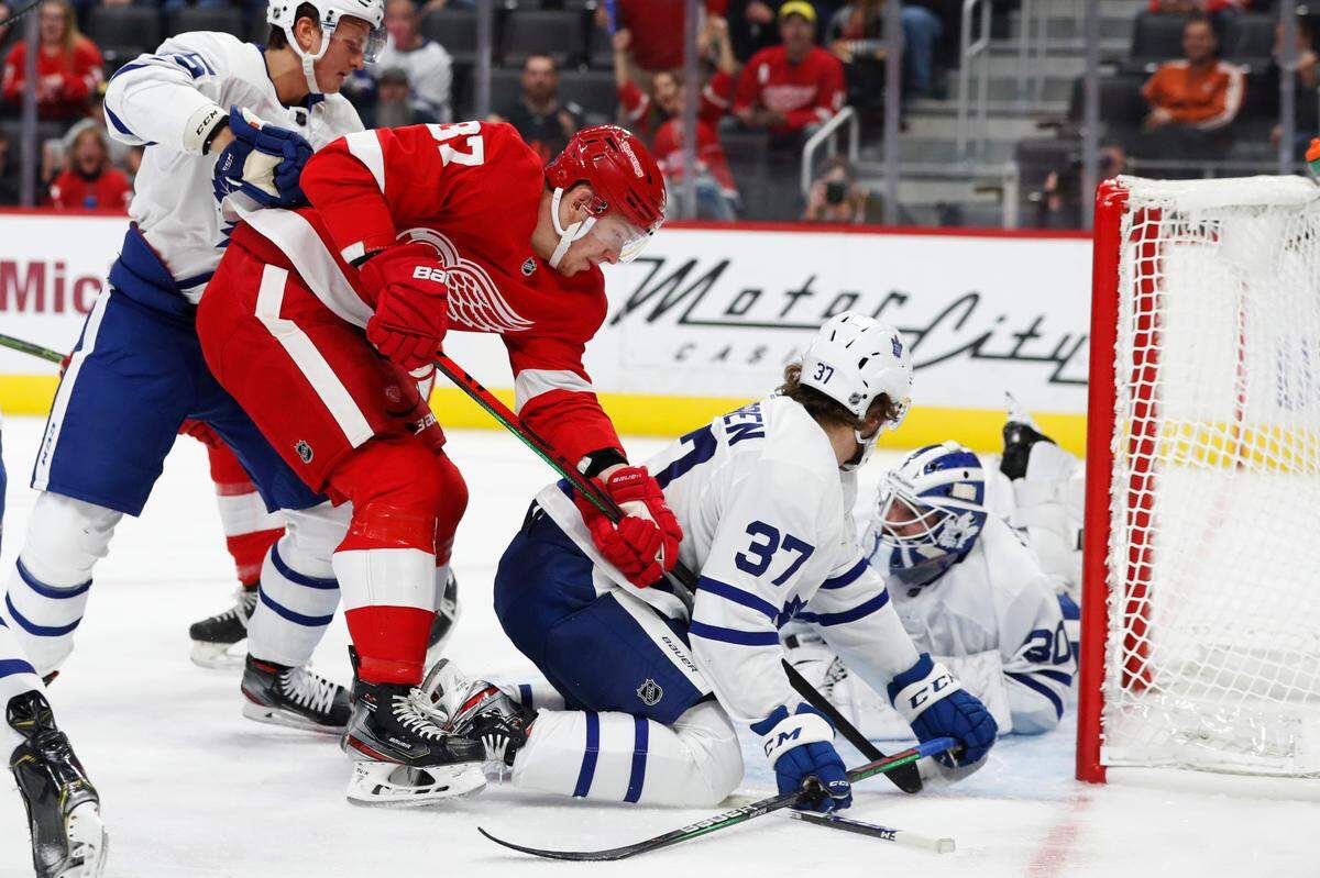 Detroit Red Wings right wing Evgeny Svechnikov (37) shoots the puck past Toronto Maple Leafs goaltender Michael Hutchinson (30) during the first period of an NHL hockey preseason game, Friday, Sept. 27, 2019, in Detroit. (AP Photo/Carlos Osorio)