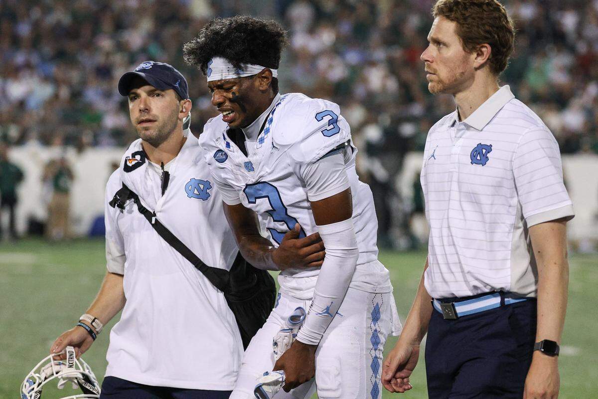 Athletic training staff escort North Carolina wide receiver Chris Culliver, center, off the field after an injury during the game against Charlotte at Jerry Richardson Stadium in Charlotte on Saturday, September 6, 2025.