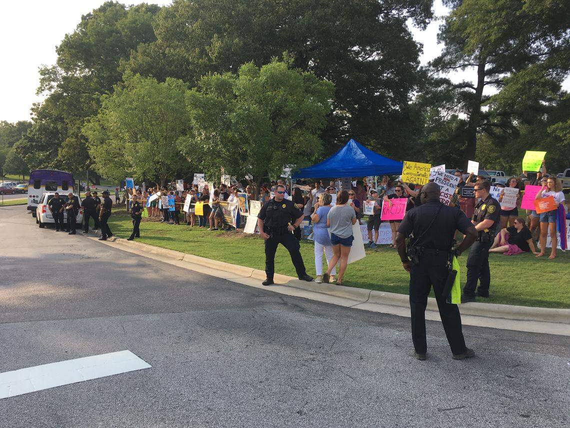 Police stand between protesters and Trump supporters at President Donald Trump’s campaign rally in Greenville, NC, on July 17, 2019.
