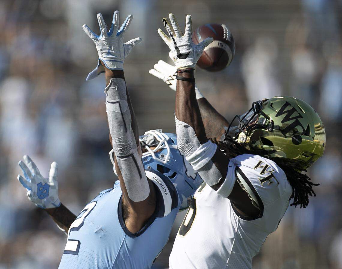 North Carolina’s Dyami Brown (2) and Wake Forest’s Ja’Sir Taylor (6) go after a 54-yard pass from quarterback Sam Howell in the first quarter at Kenan Stadium on Saturday, November 14, 2020 in Chapel Hill, N.C. Brown secured the pass. 