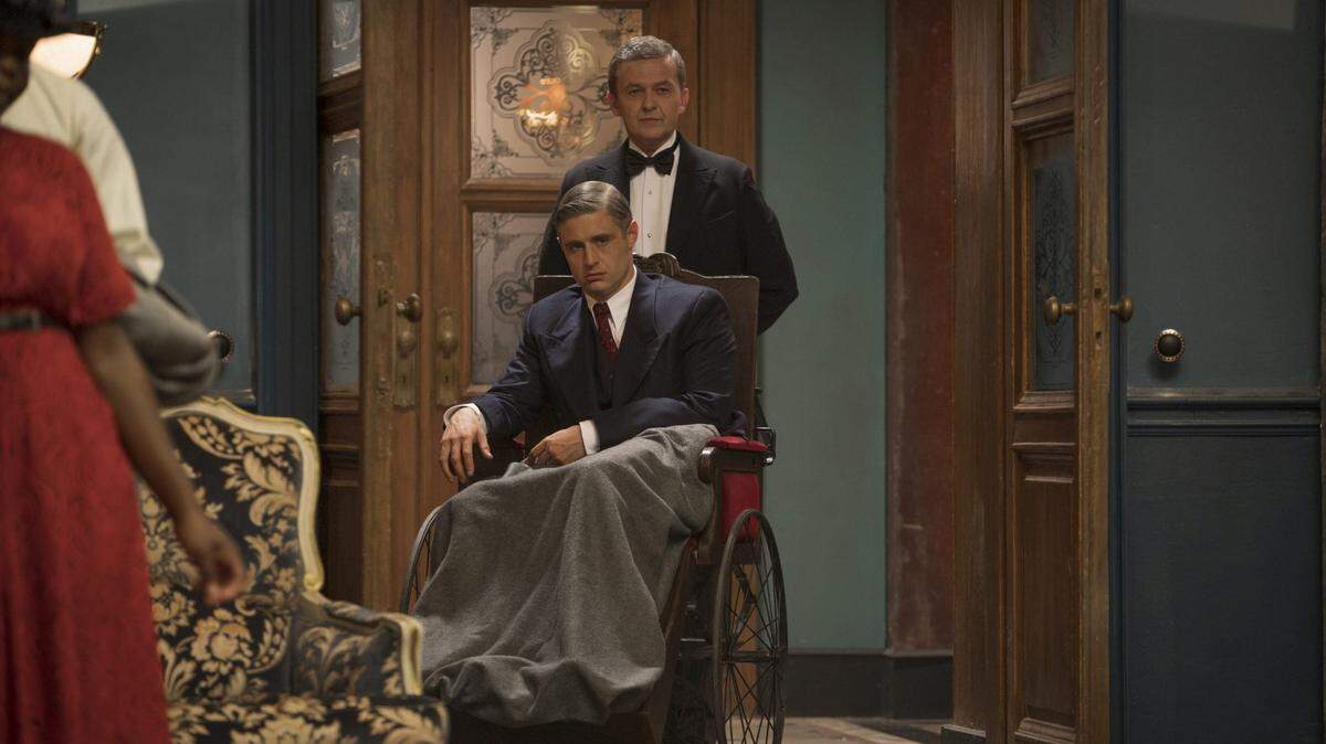 Max Irons (seated) as Malcolm Foxworth in the Lifetime limited series “Flowers in the Attic: The Origin.”
