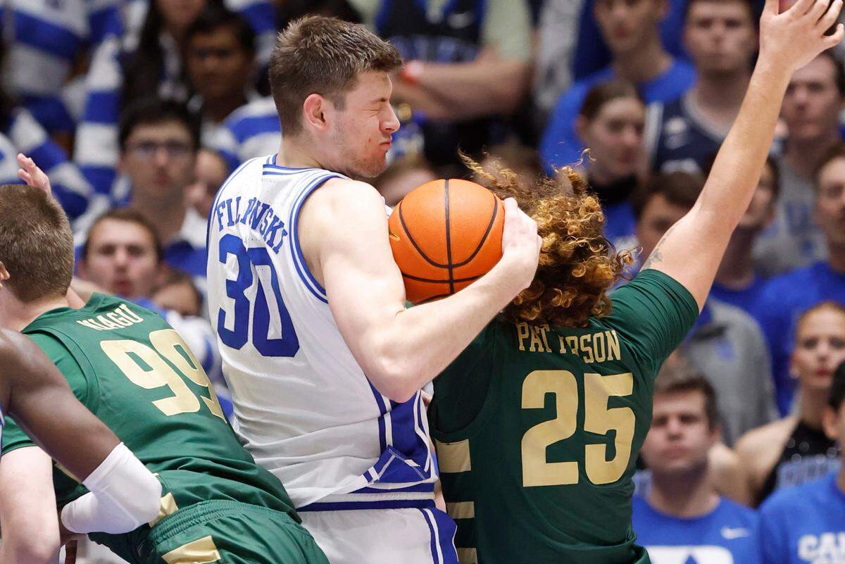 Duke’s Kyle Filipowski (30) pulls in a rebound from Charlotte’s Lu’Cye Patterson (25) during the second half of Duke’s 80-56 victory over Charlotte at Cameron Indoor Stadium in Durham, N.C., Saturday, Dec. 9, 2023.