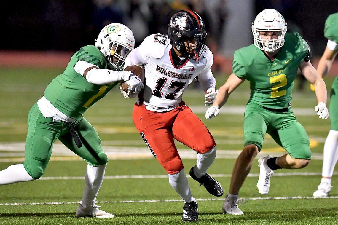 Rolesville running back Jaedon Alford 917) runs for yards against Cardinal Gibbons’ Corban McDaniel (1) and Billy Turner (2) during the second half. The Rolesville Rams and the Cardinal Gibbons Crusaders met in the East Regional Final of the NCHSAA 4A football playoffs in Raleigh, N.C. on December 13, 2024.