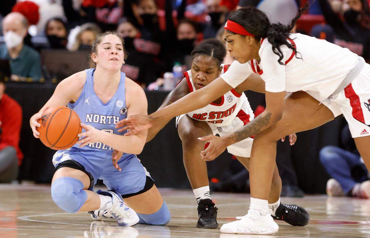 N.C. State’s Diamond Johnson (0) and Jada Boyd (5) go after the ball held by North Carolina’s Eva Hodgson (10) during the second half of N.C. State’s 72-45 victory over UNC at Reynolds Coliseum in Raleigh, N.C., Thursday, January 6, 2022.