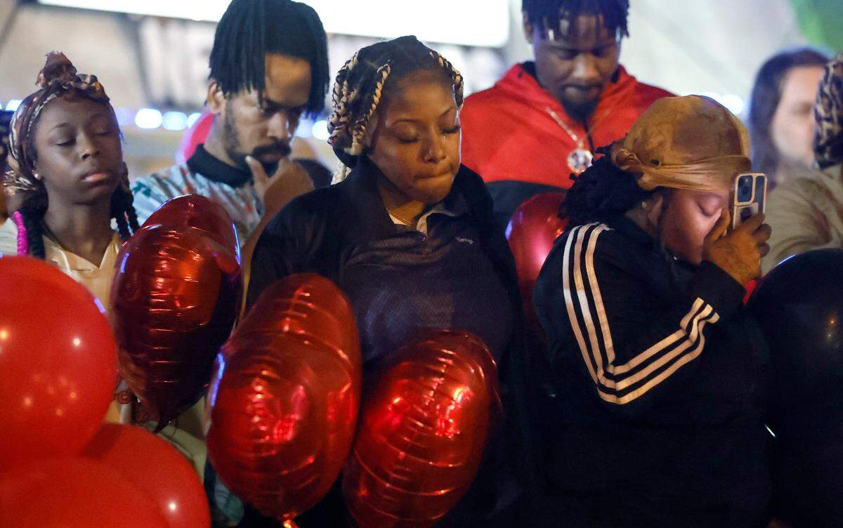Attendees observe a moment of silence during a vigil for Darryl Williams outside Supreme Sweepstakes in Raleigh, N.C., Thursday evening, Jan. 19, 2023. Williams, 32, died after he was tased by Raleigh police officers Tuesday morning.
