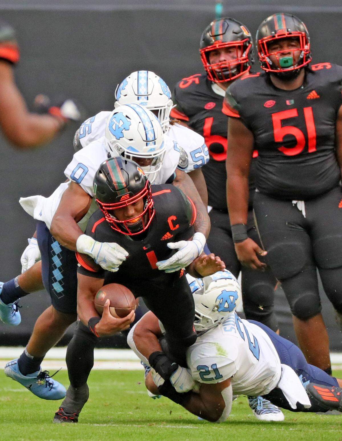 Miami Hurricanes quarterback D’Eriq King (1) is tackled by North Carolina Tar Heels linebacker Chazz Surratt (21) in the first quarter at Hard Rock Stadium In Miami Gardens, Florida, Saturday, December 12, 2020.