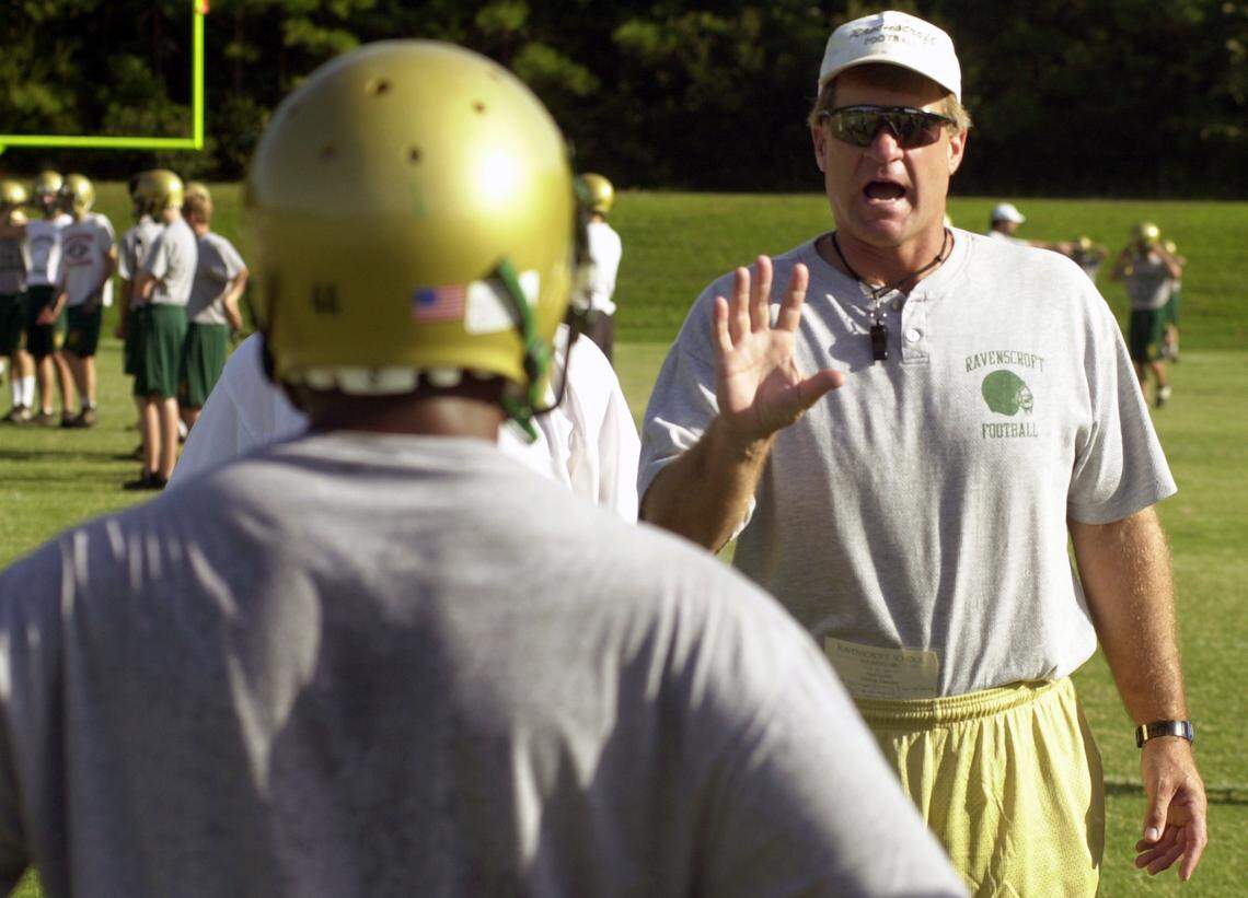 A 2002 photo shows Ravenscroft coach Ned Gonet explaining the finer points of defense to his team during a practice.