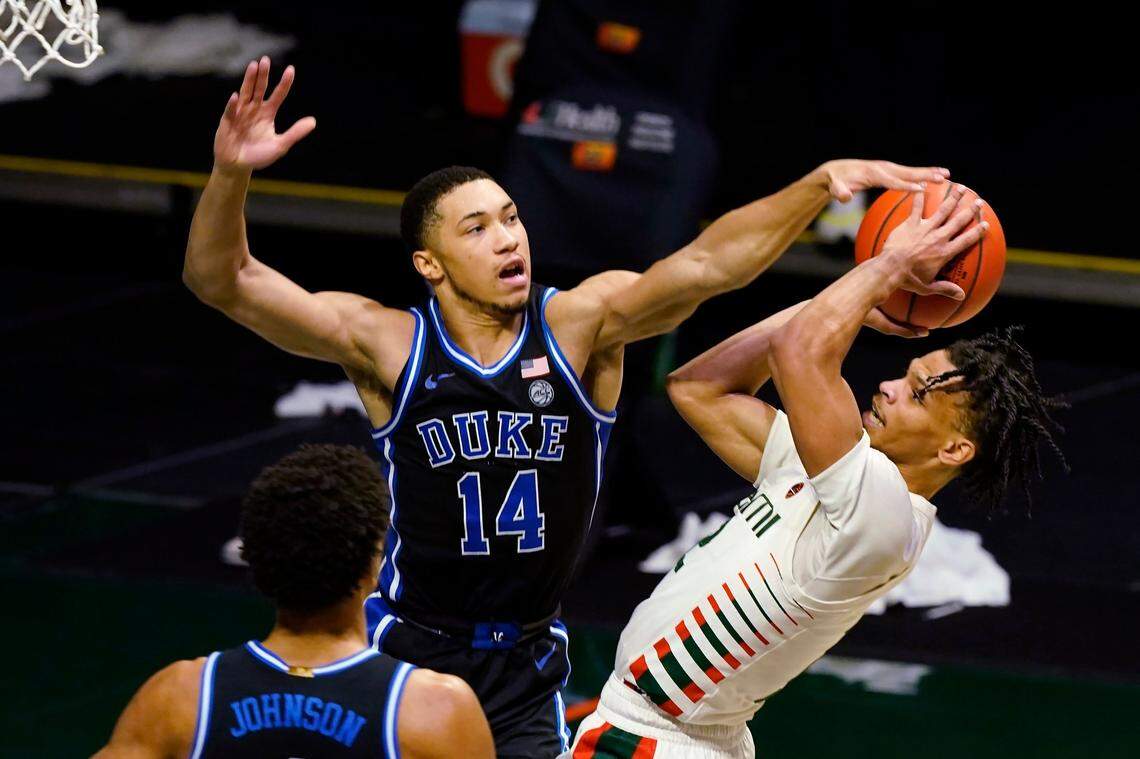 Duke guard Jordan Goldwire (14) fouls Miami guard Isaiah Wong (2) as he drives to the basket, during the second half of an NCAA college basketball game, Monday, Feb. 1, 2021, in Coral Gables, Fla.
