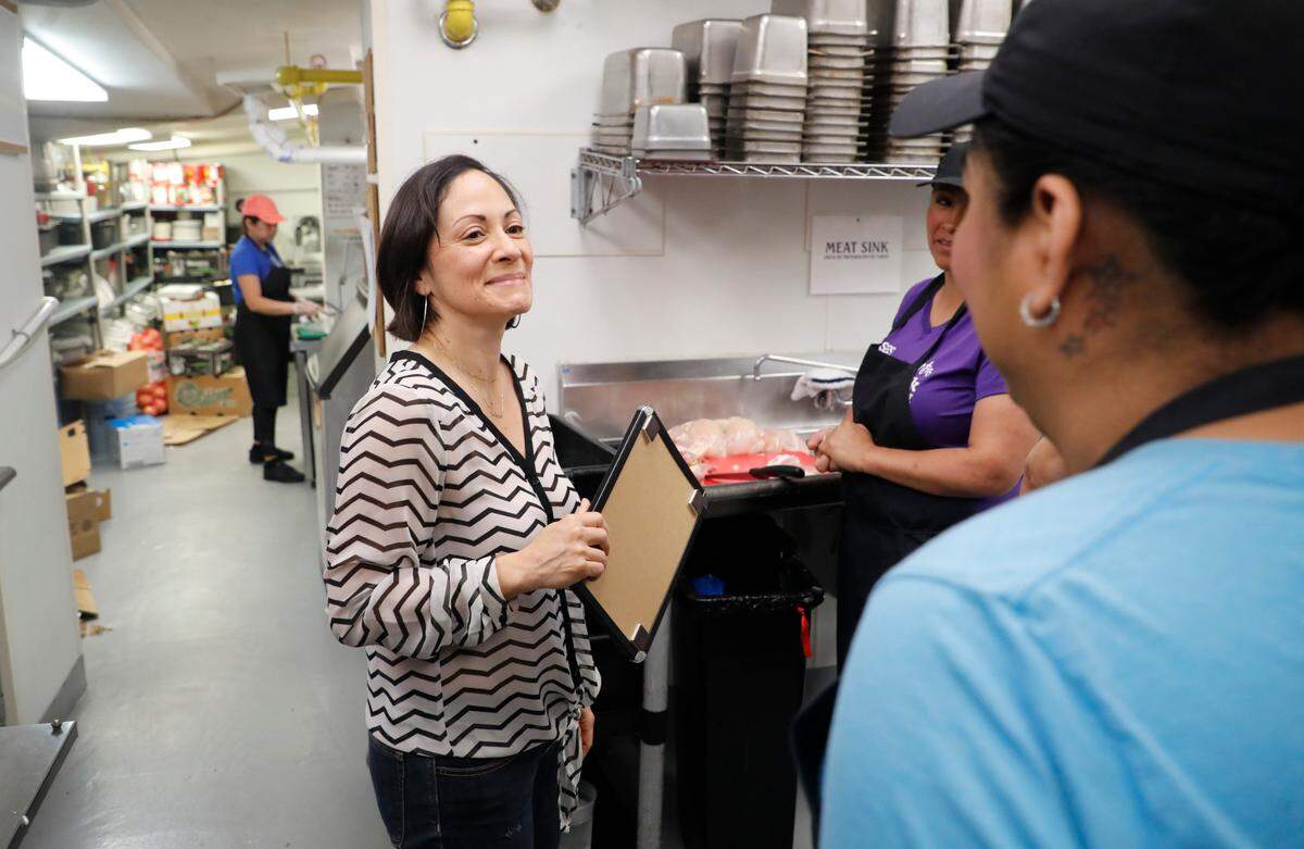 Angela Salamanca, owner of Centro restaurant in downtown Raleigh, N.C., talks with employees Emilia Cortina and Miranda Moltalvo, right, Wednesday, May 19, 2021.