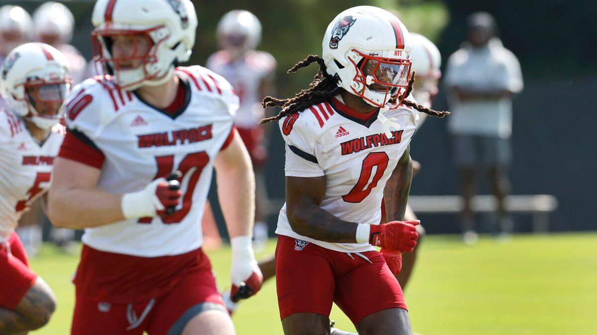 N.C. State linebacker Sean Brown (0) runs drills during the Wolfpack’s first practice in Raleigh, N.C., Wednesday, July 31, 2024. Linebacker Caden Fordham (10) is to the left.