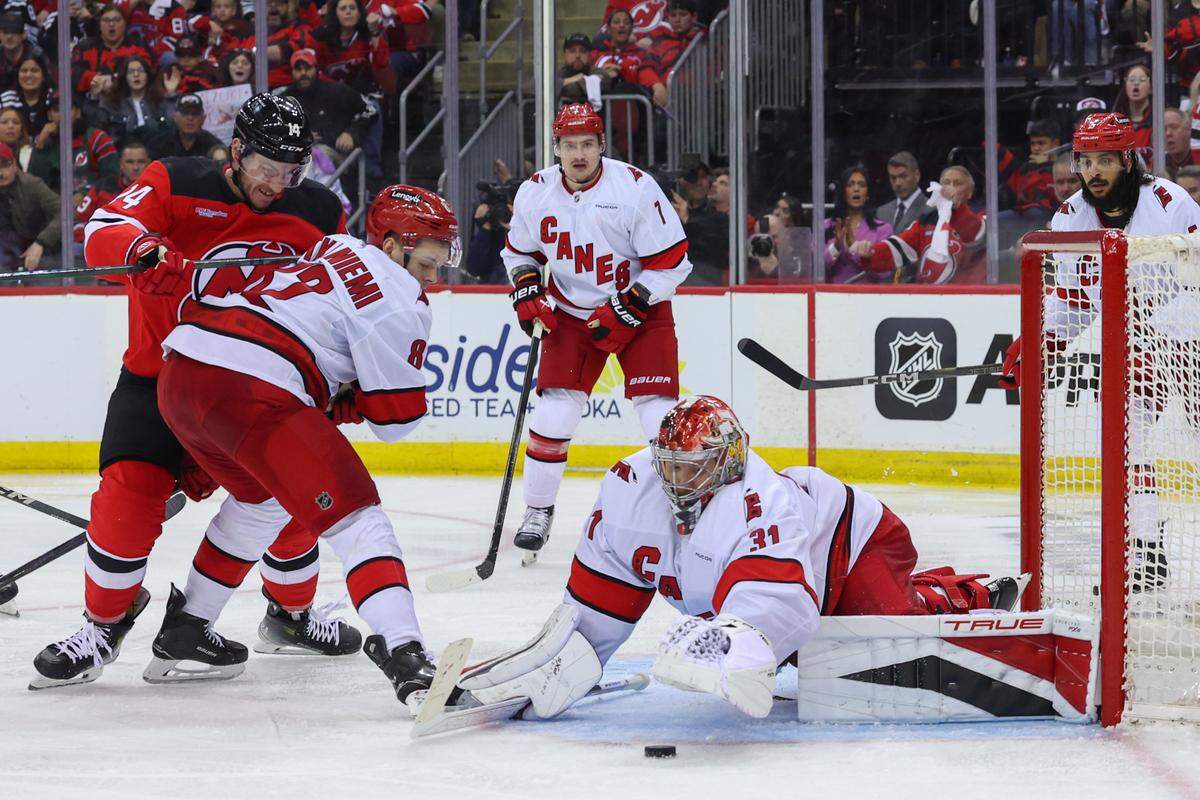 Apr 25, 2025; Newark, New Jersey, USA; Carolina Hurricanes goaltender Frederik Andersen (31) makes a save against the New Jersey Devils during the first overtime in game three of the first round of the 2025 Stanley Cup Playoffs at Prudential Center. Mandatory Credit: Ed Mulholland-Imagn Images