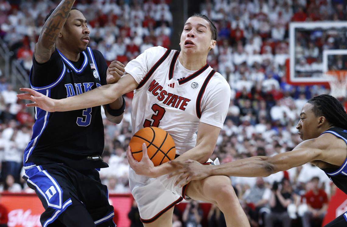 NC State's Matt Able (3) drives by Duke’s Isaiah Evans (3) and Maliq Brown (6) during the first half of Duke’s game against N.C. State at the Lenovo Center in Raleigh, N.C., Monday, March 2, 2026.