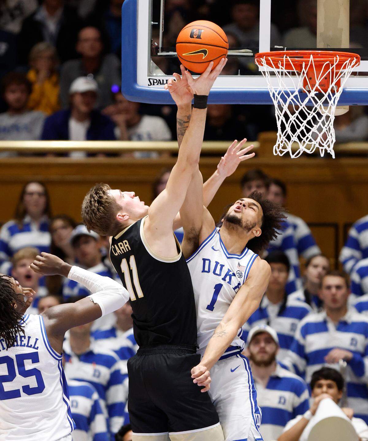 Duke’s Dereck Lively II (1) blocks the shot by Wake Forest’s Andrew Carr (11) during the second half of Duke’s 75-73 victory over Wake Forest at Cameron Indoor Stadium in Durham, N.C., Tuesday, Jan. 31, 2023.