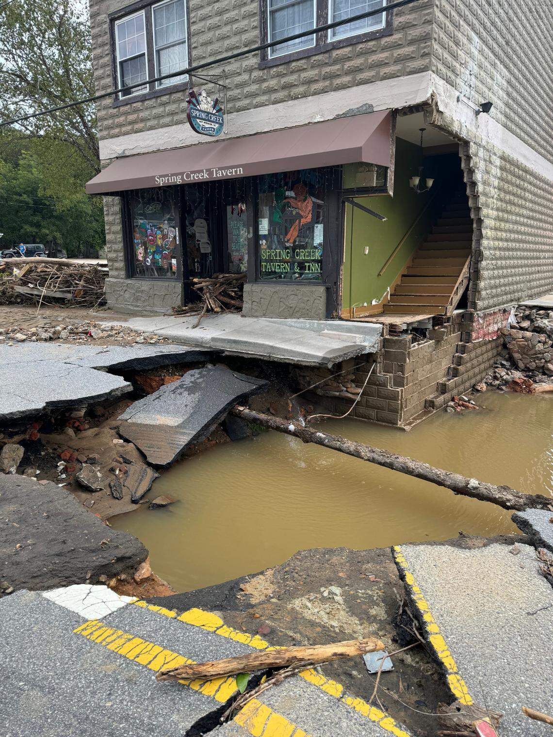 Flood waters from Helene severely damaged roads, buildings and infrastructure in the town of Hot Springs, N.C., northwest of Asheville, leaving the residents cut off from assistance.