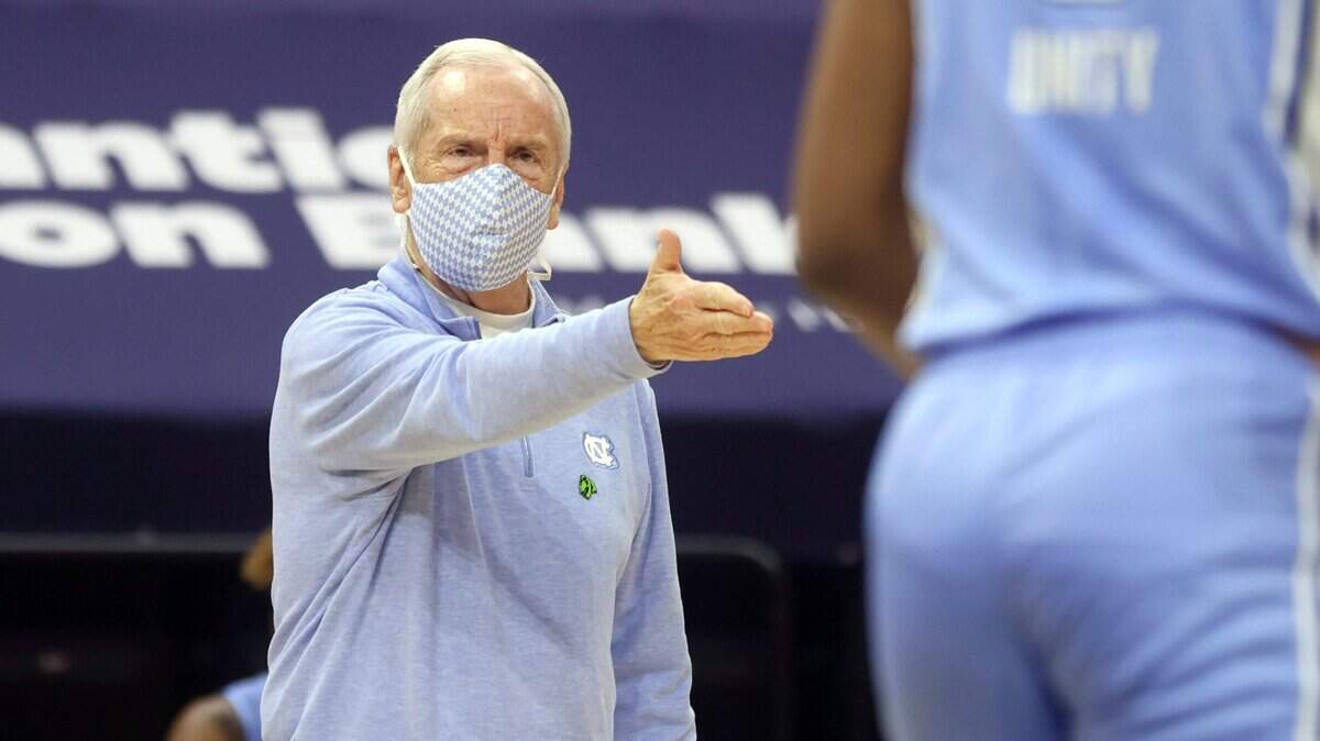 North Carolina coach Roy Williams talks with his players during the team’s NCAA college basketball game against Virginia on Saturday, Feb. 13, 2021, in Charlottesville, Va.