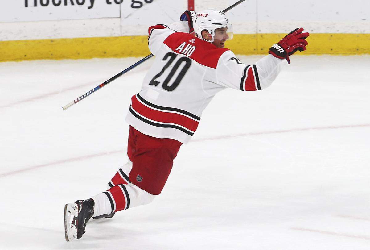 Carolina Hurricanes’ Sebastian Aho, of Finland, celebrates his game-winning goal against Minnesota Wild goalie Devan Dubnyk in overtime of an NHL hockey game Saturday, Oct. 13, 2018, in St. Paul, Minn. The Hurricanes won 5-4.