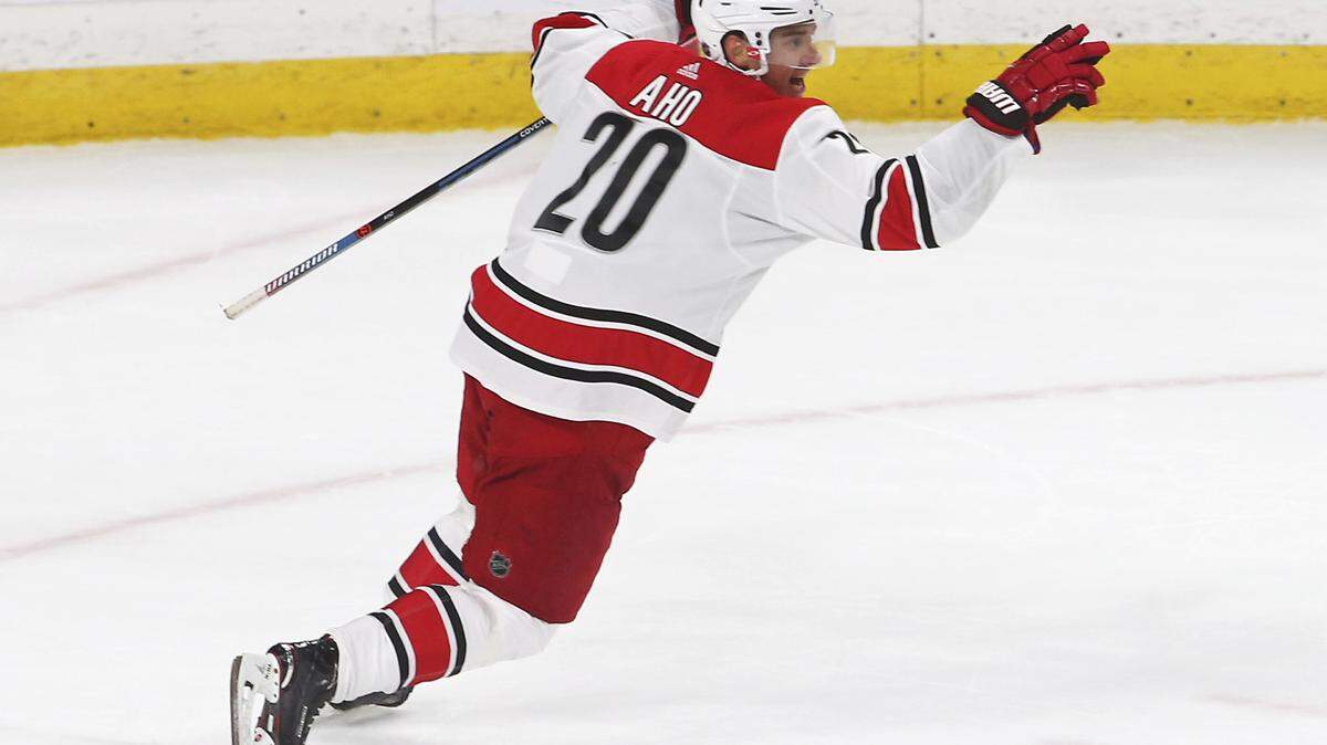 Carolina Hurricanes’ Sebastian Aho, of Finland, celebrates his game-winning goal against Minnesota Wild goalie Devan Dubnyk in overtime of an NHL hockey game Saturday, Oct. 13, 2018, in St. Paul, Minn. The Hurricanes won 5-4.