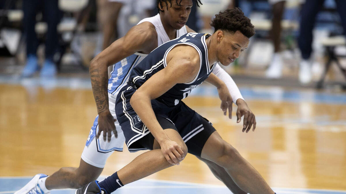 North Carolina’s Caleb Love (2) forces a turnover by Duke’s Wendell Moore Jr. (0) during the first half on Saturday, March 6, 2021 at the Smith Center in Chapel Hill, N.C.