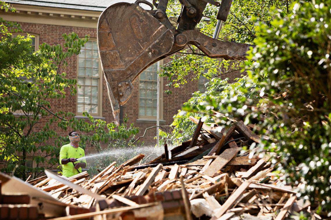 The remnants of three homes on White Oak Road in Raleigh are removed to make way for a parking lot behind Hayes Barton Baptist Church in Raleigh on Tuesday morning, June 7, 2022.