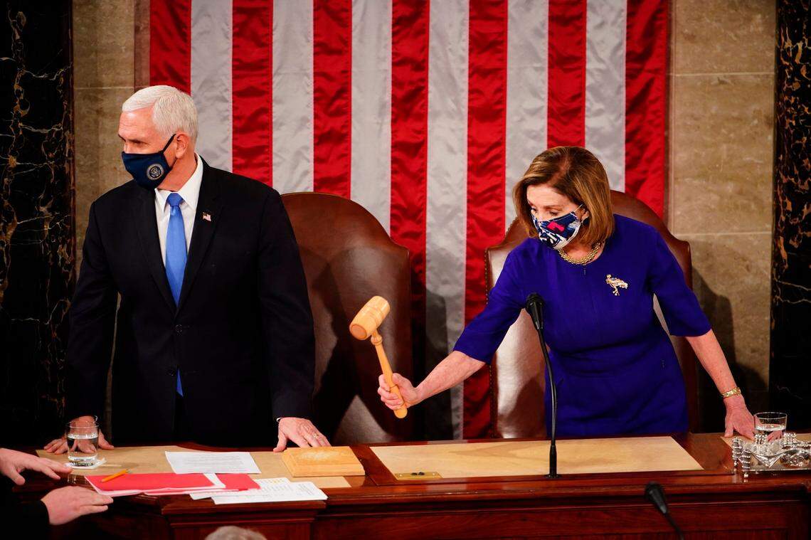 Speaker of the House Nancy Pelosi, D-Calif., and Vice President Mike Pence officiate as a joint session of the House and Senate convenes to confirm the Electoral College votes cast in November’s election, at the Capitol in Washington, Wednesday, Jan. 6, 2021.