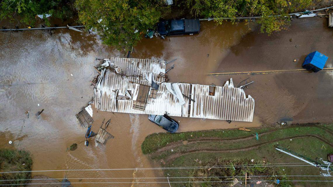 Part of a structure sits in floodwaters on a road in Canton on Friday, Sept. 27, 2024 as the remnants of Hurricane Helene caused flooding, downed trees, and power outages in western North Carolina.