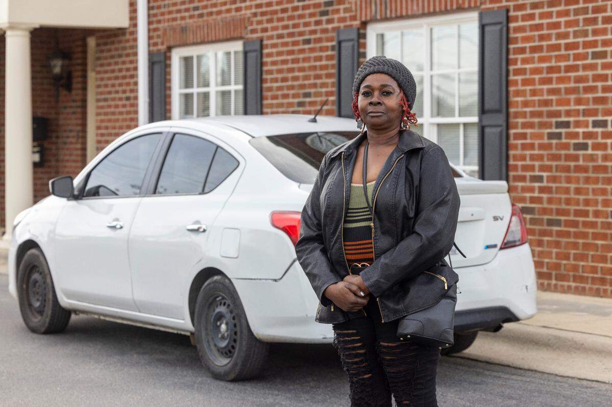 Jacqueline McNeill of Hope Mills was arrested by Fayetteville Police and wrongly accused of a shooting in 2022. Police used an automated license plate reader camera to connect her to the crime. After several hours of interrogation, she was released when police realized they had the wrong person. McNeill was photographed on Jan. 12, 2024 with the white Nissan Versa she was driving the day of the arrest.