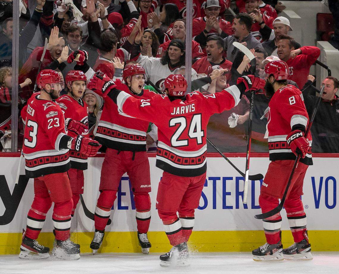 Carolina Hurricanes’ Sebastian Aho (20) celebrates with teammates Stefan Noesen (23), Martin Necas (88), Seth Jarvis (24) and Brent Burns (8) after scoring on New York Islanders goalie Ilya Sorokin (30) to take a 1-0 lead on Monday, April 17, 2023 at PNC Arena in Raleigh, N.C.