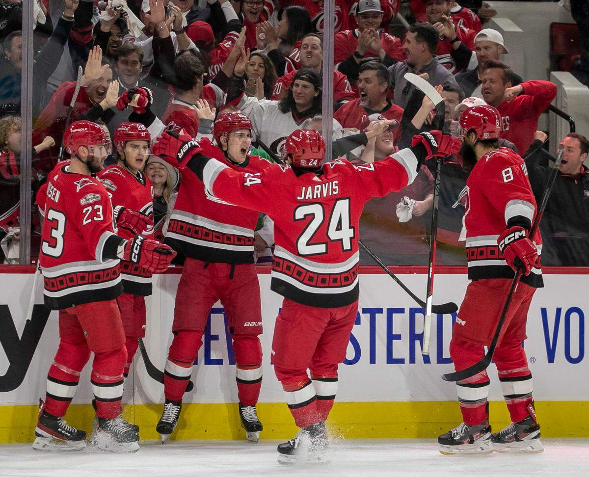 Carolina Hurricanes’ Sebastian Aho (20) celebrates with teammates Stefan Noesen (23), Martin Necas (88), Seth Jarvis (24) and Brent Burns (8) after scoring on New York Islanders goalie Ilya Sorokin (30) to take a 1-0 lead on Monday, April 17, 2023 at PNC Arena in Raleigh, N.C.