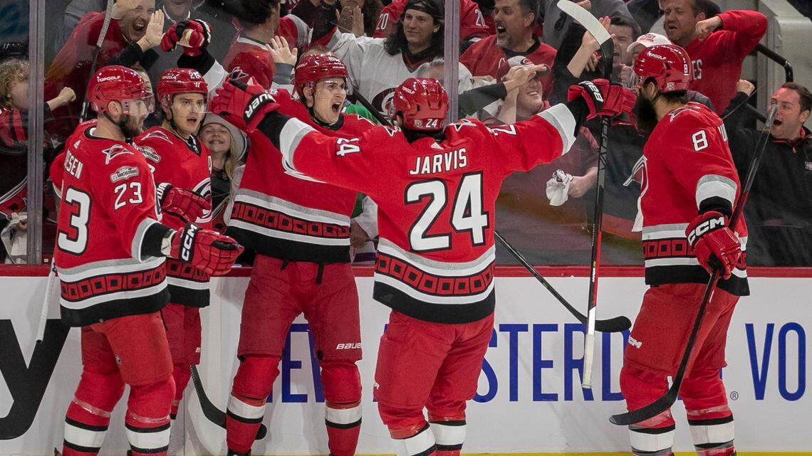 Carolina Hurricanes’ Sebastian Aho (20) celebrates with teammates Stefan Noesen (23), Martin Necas (88), Seth Jarvis (24) and Brent Burns (8) after scoring on New York Islanders goalie Ilya Sorokin (30) to take a 1-0 lead on Monday, April 17, 2023 at PNC Arena in Raleigh, N.C.