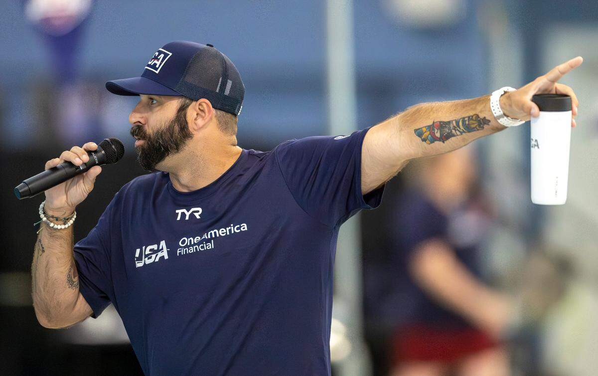 N.C. State swimming coach Braden Holloway, an assistant Olympic swim coach, addresses the crowd during the 2024 United States Olympic Swim Team practice on Saturday, July 6, 2024 at the Triangle Aquatic Center in Cary, N.C.