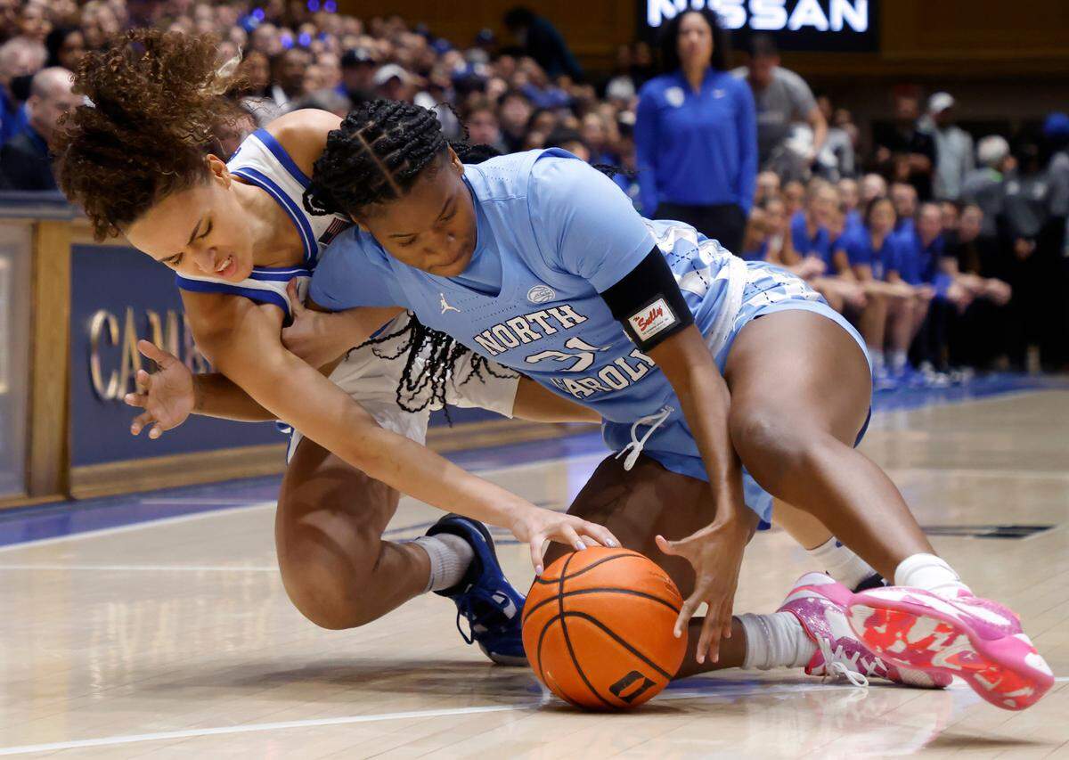 Duke’s Celeste Taylor and North Carolina’s Anya Poole dive for a loose ball during the first half of the Blue Devils’ regular season finale against North Carolina on Sunday, Feb. 26, 2023, at Cameron Indoor Stadium in Durham, N.C.