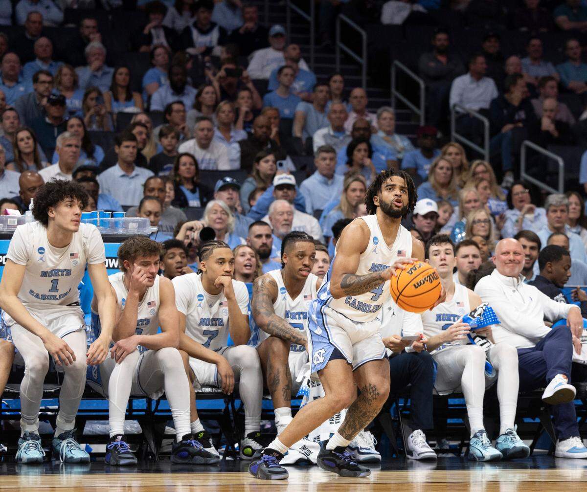 North Carolina’s R.J. Davis (4) sets up for a three point attempt in front of the the Tar Heels’ bench in the second half against Wagner on Thursday, March 21, 2024 during the NCAA Tournament at Spectrum Center in Charlotte, N.C.