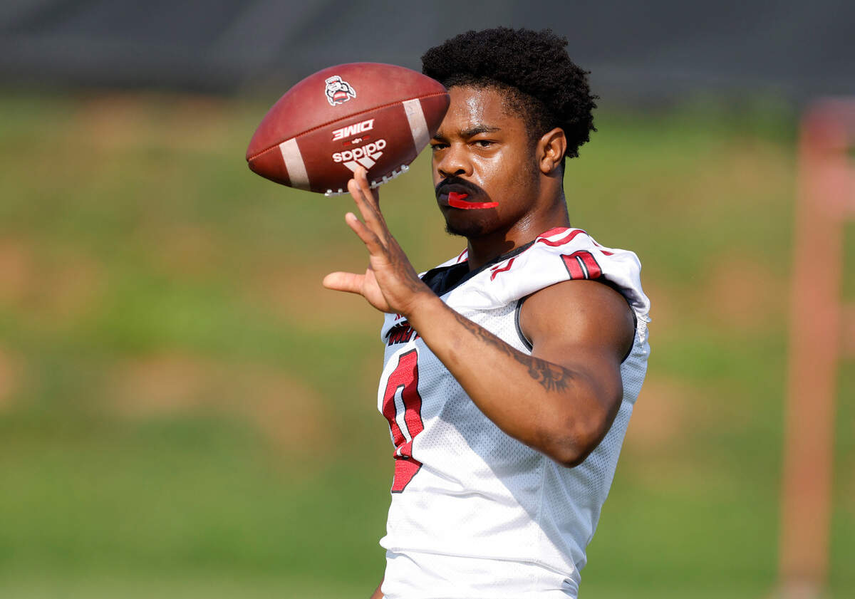 N.C. State running back Demie Sumo-Karngbaye (0) plays with the ball before the start of the Wolfpack’s first practice of fall camp in Raleigh, N.C., Wednesday, August 3, 2022.