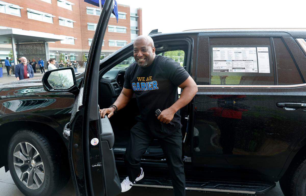 Terry Hennings gets out of the 2023 Chevy Tahoe donated by Capital Chevrolet after a celebration at Garner High School Friday, April 28, 2023. Hennings, a Civic Literacy and African American Studies teacher at Garner High, gets the Tahoe for a year as part of the prizes he was given after being named the 2023 Wake County Teacher of the Year.