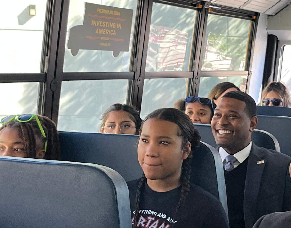 Environmental Protection Agency Administrator Michael Regan rides with Durham Public Schools students on an electric bus on Wednesday, Oct. 23, 2024.