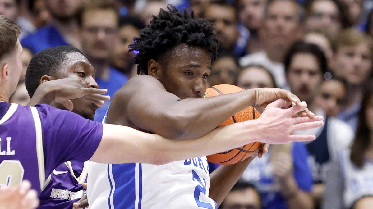 Duke’s Patrick Ngongba (21) pulls in the rebound from Western Carolina's Marcus Kell (23) during the first half of Duke’s game against Western Carolina at Cameron Indoor Stadium in Durham, N.C., Saturday, Nov. 8, 2025.