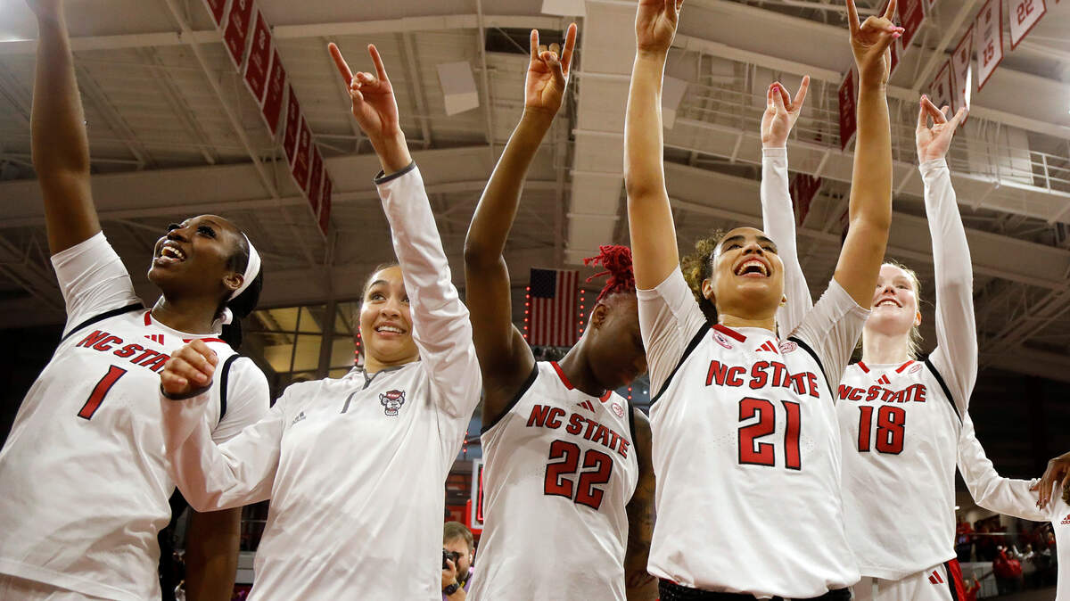 N.C. State celebrates after its 104-95 double overtime victory over Notre Dame on Sunday, Feb. 23, 2025, at Reynolds Coliseum in Raleigh, N.C.