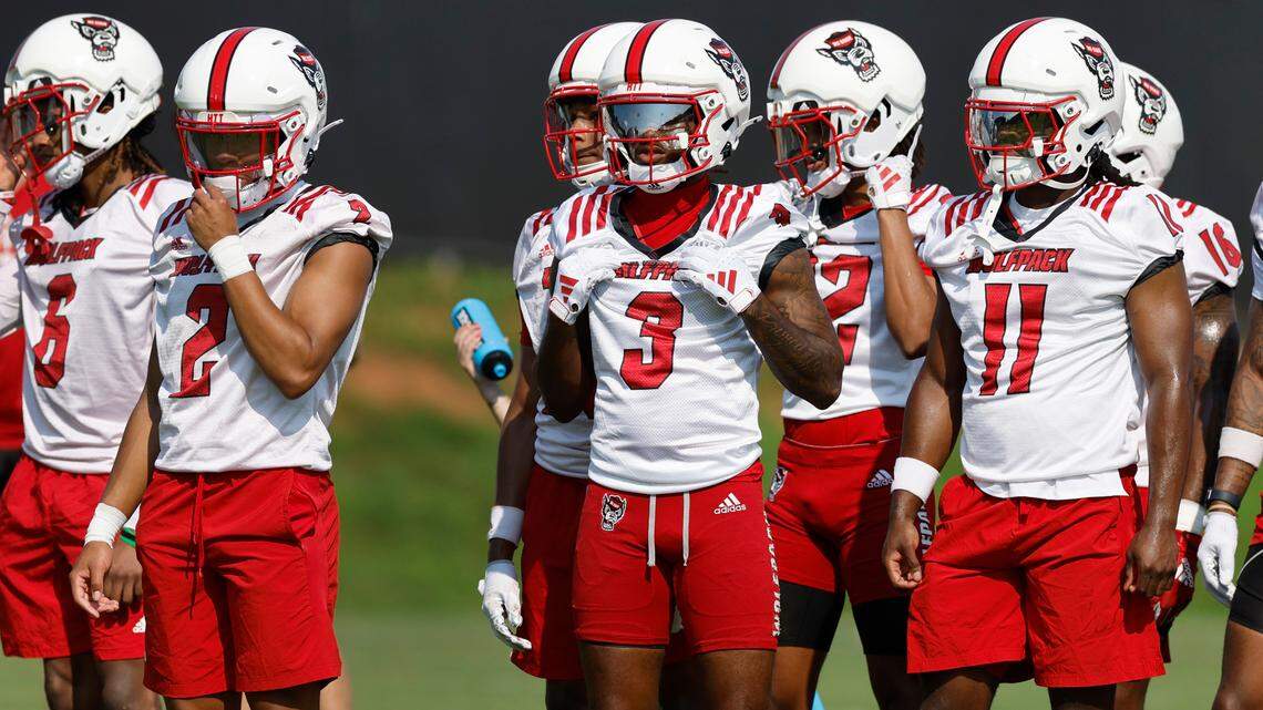 From left, N.C. State’s Brandon Cisse (2), Aydan White (3) and Ja’Had Carter (11) watch a drill during the Wolfpack’s first practice in Raleigh, N.C., Wednesday, July 31, 2024.