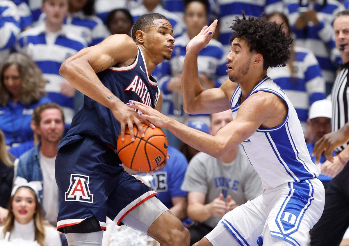 Duke’s Jared McCain (0) knocks the ball Arizona’s Keshad Johnson (16) during the second half of Arizona’s 78-73 victory over Duke at Cameron Indoor Stadium in Durham, N.C., Friday, Nov. 10, 2023.