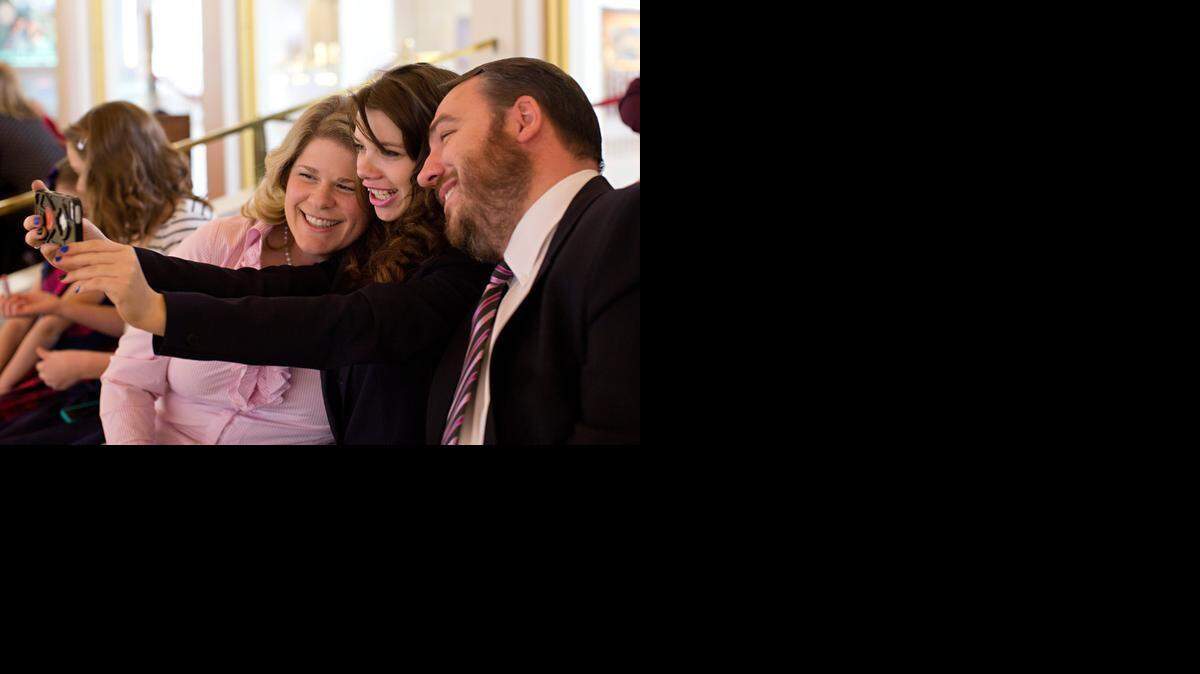 Nastya, 17, takes a selfie with Kristy and Michael Johnson while seated in the second-floor balcony during a visit to the North Carolina General Assembly on Tuesday. Nastya was recognized by state lawmakers.
