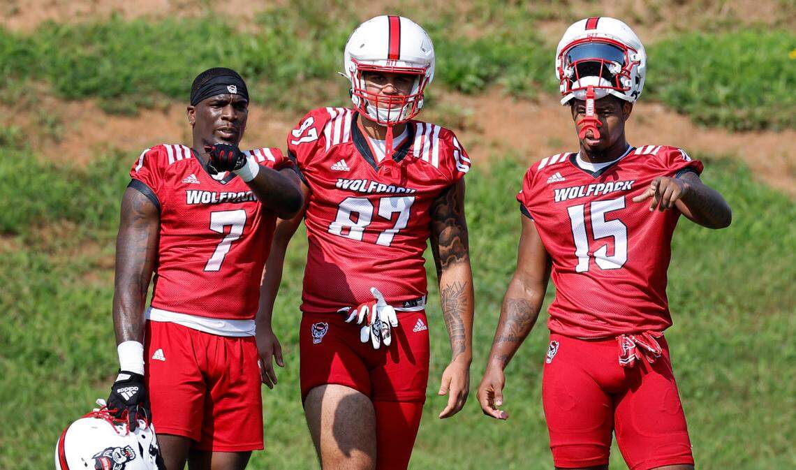 N.C. State’s Jordan Waters (7) talks with Jayden Hollar (87) and Justin Joly (15) during the Wolfpack’s first practice in Raleigh, N.C., Wednesday, July 31, 2024.