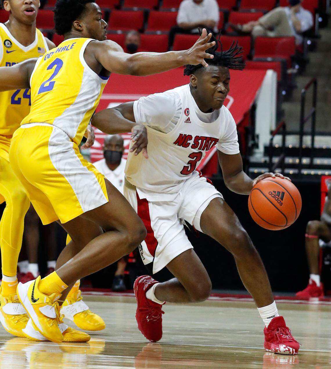 N.C. State’s Cam Hayes (3) drives around Pittsburgh’s Femi Odukale (2) during the second half of N.C. State’s 65-62 victory over Pittsburgh at PNC Arena in Raleigh, N.C., Sunday, February 28, 2021.
