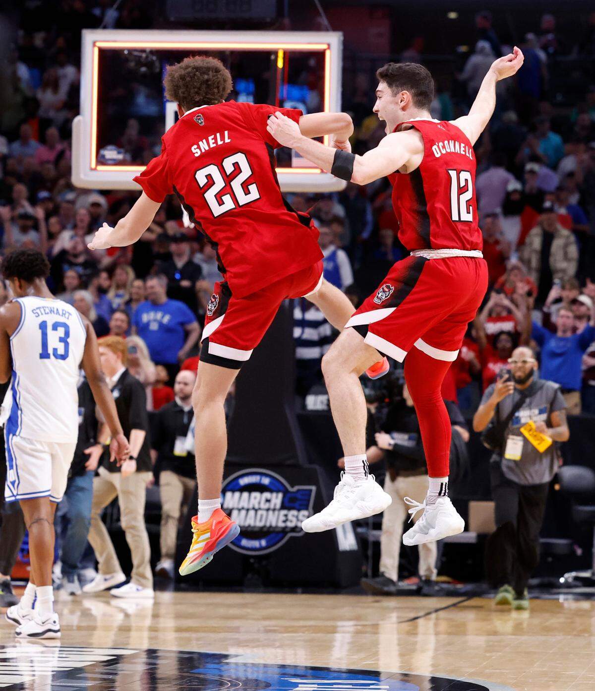 N.C. State’s Jordan Snell (22) and N.C. State’s Michael O’Connell (12) celebrate as time expires in N.C. State’s 76-64 victory over Duke in their NCAA Tournament Elite Eight matchup at the American Airlines Center in Dallas, Texas, Sunday, March 31, 2024.