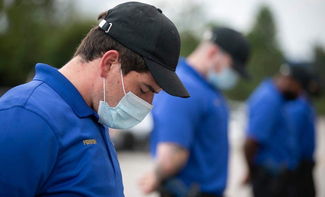 Members of the Wake Tech Community College Basic Law Enforcement Training class bow their heads in prayer at the Chapanoke Road campus in Raleigh on Friday to honor the 19th anniversary of the Sept. 11, 2001, terrorist attack.