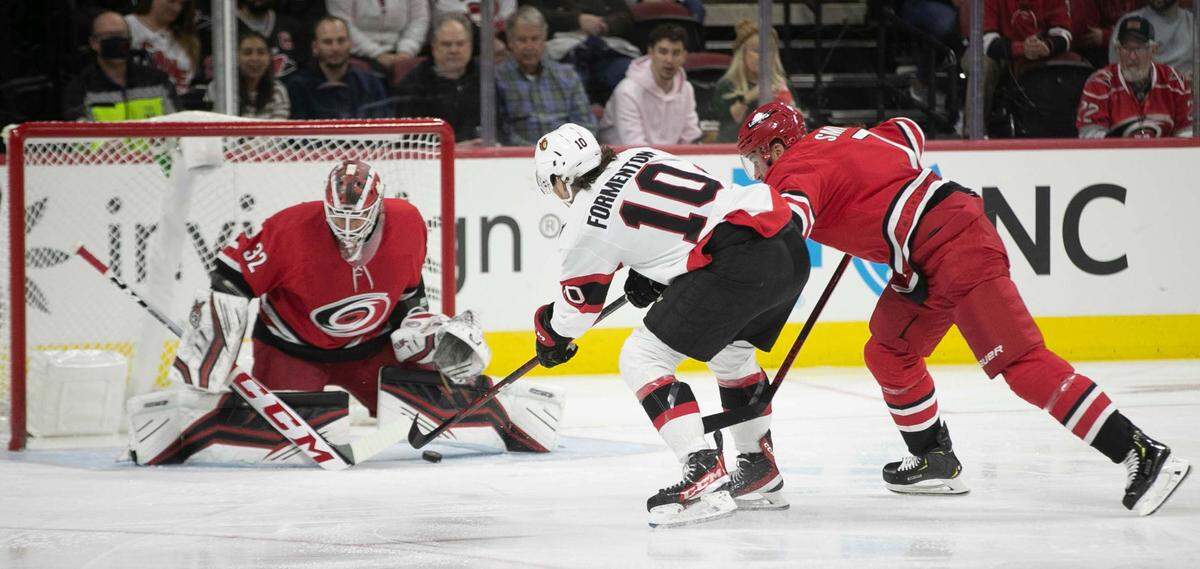 Ottawa’s Alex Formenton (10) scores on Carolina Hurricanes’ goalie Antii Raanta (32) in the first period to take a 1-0 lead on Thursday, December 2, 2021 at PNC Arena in Raleigh, N.C.