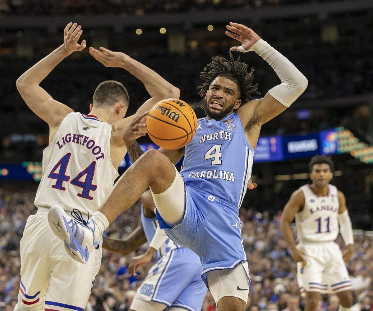 North Carolinas R.J. Davis (4) tangles with Kansas Mitch Lightfoot (44) for a rebound during the first half of the NCAA Championship game on Monday, April 4, 2022 at Caesars Superdome in New Orleans, La.