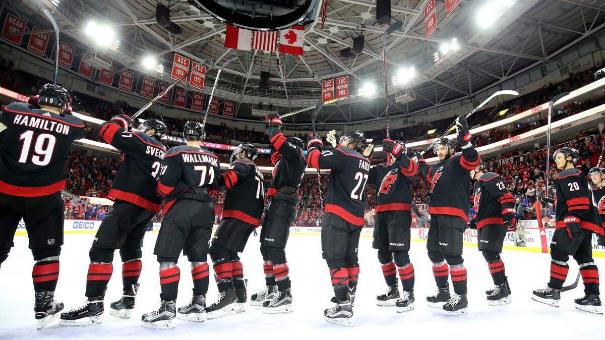 The Carolina Hurricanes acknowledge their fans as theycelebrate their 8-5 win over the New York Rangers Sunday, Oct. 7, 2018. 