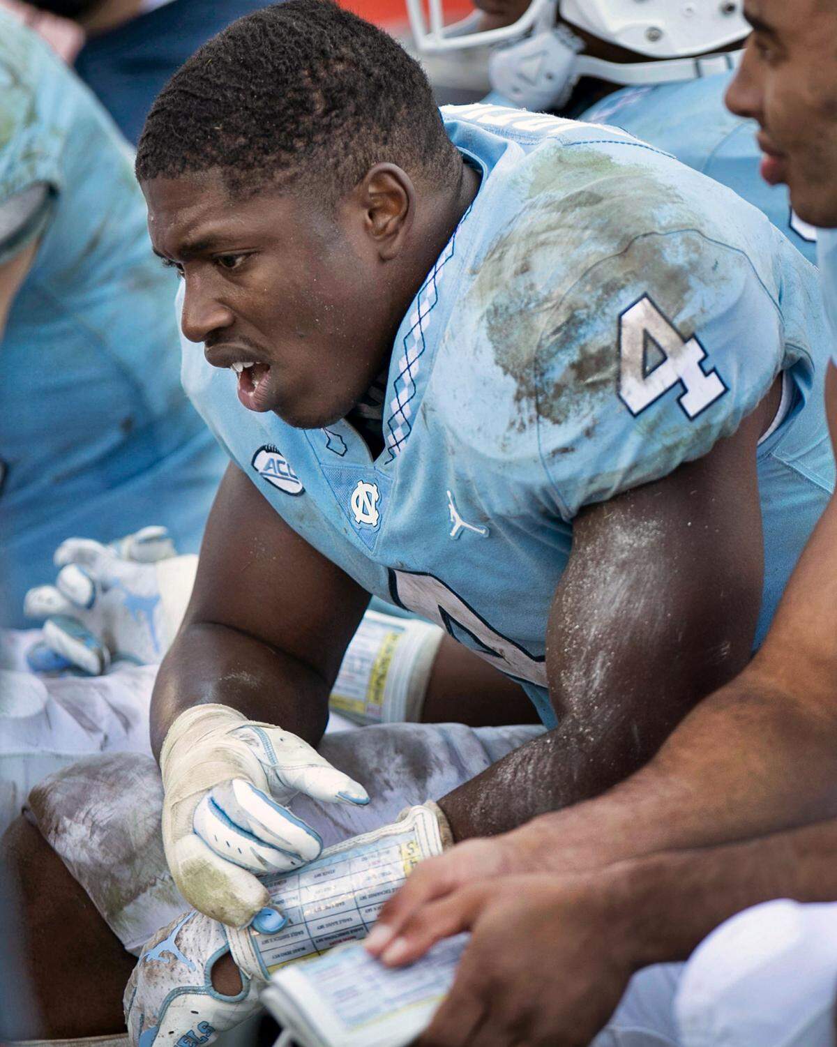 North Carolina safety Allen Artis (4) takes a seat on the bench following the final Georgia Tech touchdown to secure the Yellowjackets’ 38-28 victory on Saturday, November 3, 2018 at Kenan Stadium in Chapel Hill, N.C.