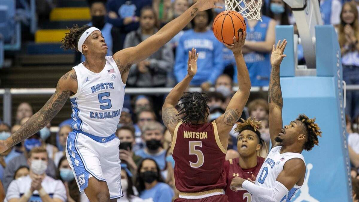 North Carolina’s Armando Bacot (5) and Anthony Harris (0) defend Elon’s Torrence Watson (5) in the first half on Saturday, December 11, 2021 at the Smith Center in Chapel Hill, N.C.